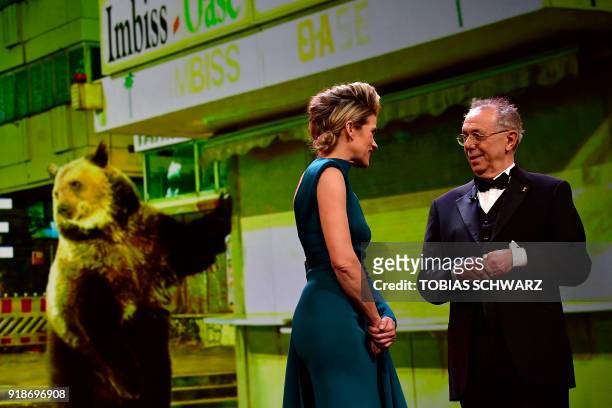 German TV host Anke Engelke and Berlinale Director Dieter Kosslick stand on stage during the opening ceremony of the 68th Berlinale film festival...