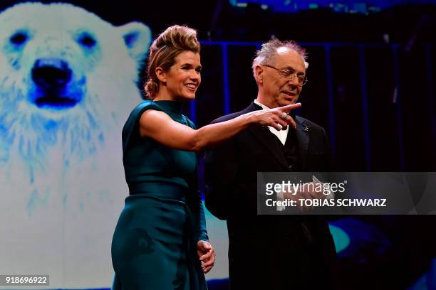 German TV host Anke Engelke and Berlinale Director Dieter Kosslick stand on stage during the opening ceremony of the 68th Berlinale film festival...