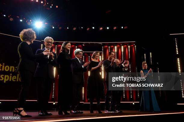 German director and president of the jury Tom Tykwer , German TV host Anke Engelke stand on stage with jury members Belgian actress Cecile de France...