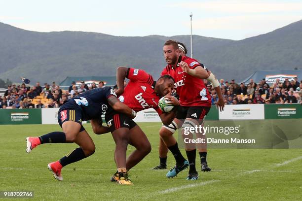 Manasa Mataele of the Crusaders tries to break the tackle of Tevita Li of the Highlanders during the Super Rugby trial match between the Highlanders...