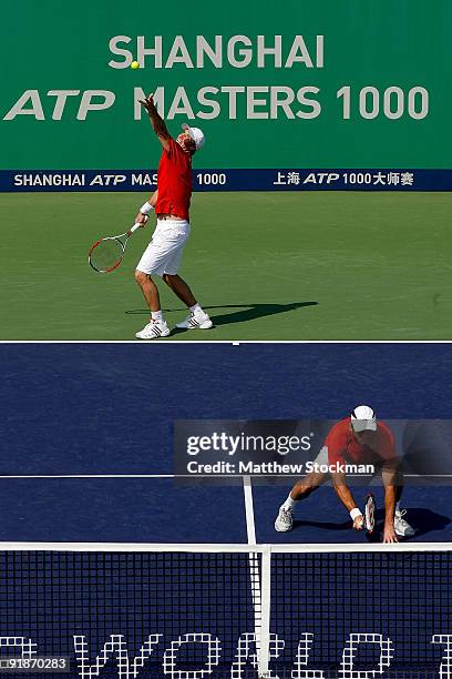 Simon Aspelin of Sweden serves to Mike Bryan of the United States while playing with Paul Hanley of Australia during the 2009 Shanghai ATP Masters...