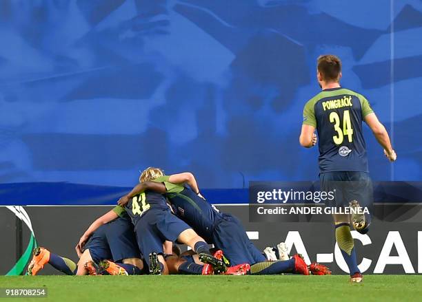 Salzburg players celebrate their second goal during the UEFA Europa League first leg round of 32 football match between Real Sociedad and FC Salzburg...