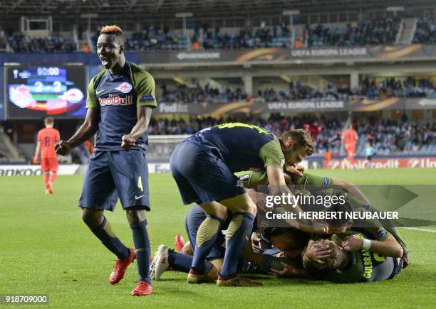 Salzburg's Malian midfielder Amadou Haidara and teammates celebrate their second goal during the UEFA Europa League first leg round of 32 football...