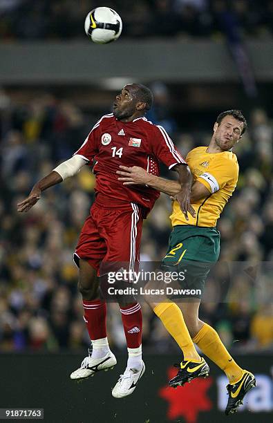 Hassan Rabia of Oman and Lucas Neill of Australia jump for the ball during the Asian Cup Group B qualifying match between the Australian Socceroos...