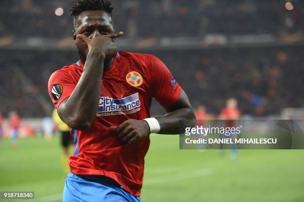 Steaua Bucharest's French forward Harlem Gnohere celebrates after scoring during the UEFA Europa League round of 32 first leg football match Steaua...