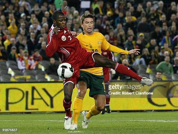 Mohamed Rabia of Oman tackles Harry Kewell of Australia during the Asian Cup Group B qualifying match between the Australian Socceroos and Oman at...