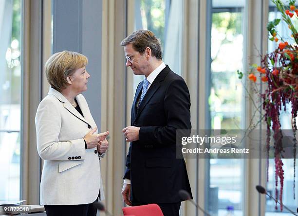 German Chancellor and Chairwoman of the German Christian Democrats Angela Merkel talks to Guido Westerwelle, leader of the German Free Democrats ,...