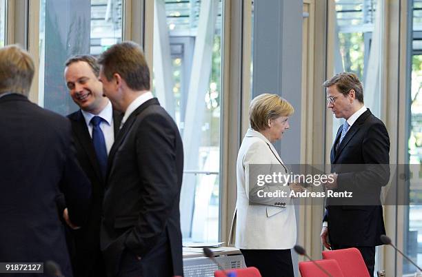 German Chancellor and Chairwoman of the German Christian Democrats Angela Merkel talks to Guido Westerwelle, leader of the German Free Democrats ,...