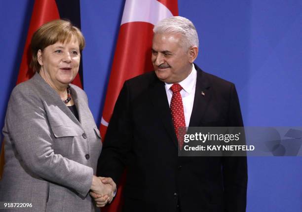 German Chancellor Angela Merkel shakes hands with Turkish Prime Minister Binali Yildirim after a press conference on February 15, 2018 at the...