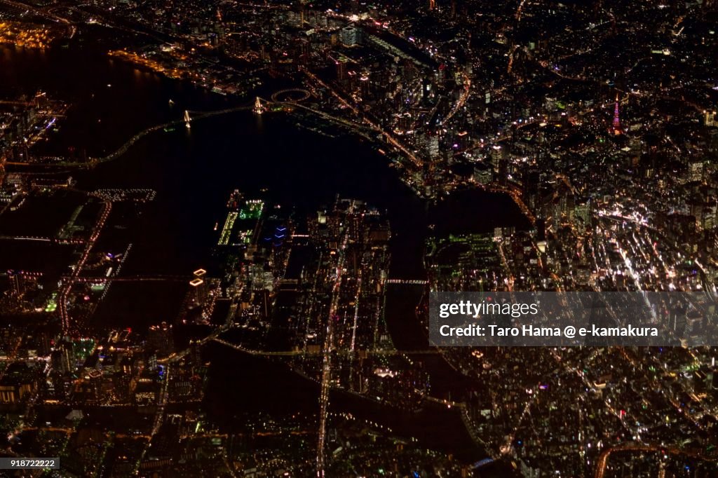 Tokyo Rainbow Bridge, Tokyo Tower, Ginza and Shinagawa area in Tokyo in Japan night time aerial view from airplane