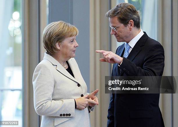 German Chancellor and Chairwoman of the German Christian Democrats Angela Merkel talks to Guido Westerwelle, leader of the German Free Democrats ,...