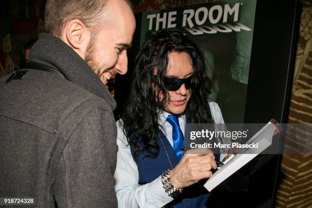 Actor Piotr Wieczorkiewicz a.k.a. Tommy Wiseau signs an autograph as he attends 'The Disaster Artist' Premiere at Le Grand Rex on February 15, 2018...