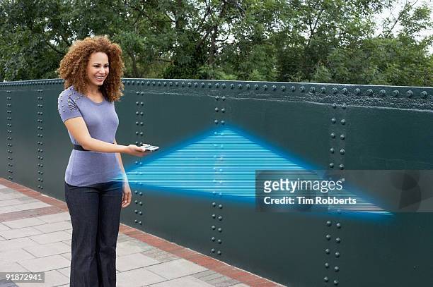 woman using pda with satnav hologram - satnav photos et images de collection