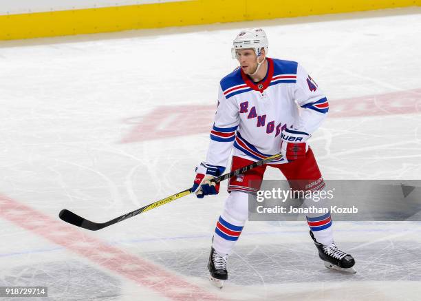 Steven Kampfer of the New York Rangers keeps an eye on the play during second period action against the Winnipeg Jets at the Bell MTS Place on...