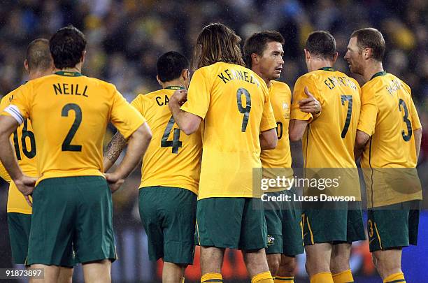 Harry Kewell of Australia organizes the wall during the Asian Cup Group B qualifying match between the Australian Socceroos and Oman at Etihad...