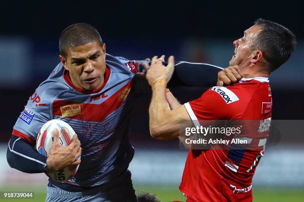 David Mead of the Catalans Dragons pushes aside Hull KR's Danny McGuire during the BetFred Super League match between Hull KR and Catalans Dragons at...