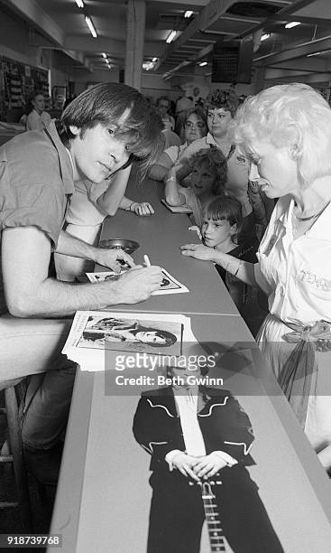 Country singer and songwriter signs autographs at Fan Fair on June 10, 1986 in Nashville, Tennessee.