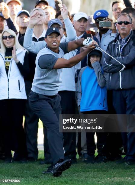 Tiger Woods plays his shot on the 12th hole during the first round of the Genesis Open at Riviera Country Club on February 15, 2018 in Pacific...