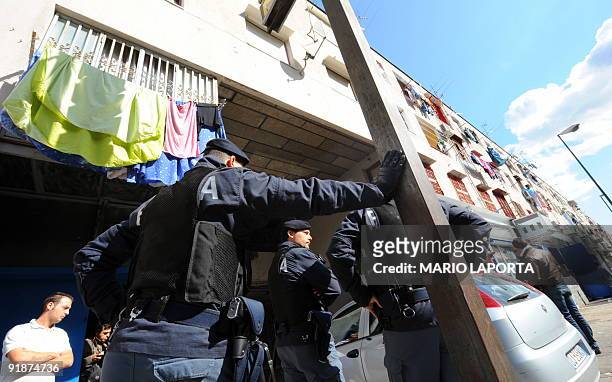 Policemen patrol the streets during an operation against drug smugglers in Scampia, a quarter of Naples called "il supermercato della droga" on...