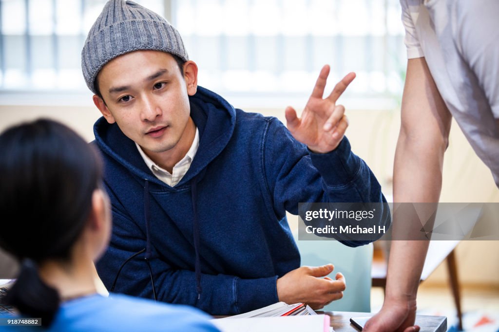 Young businessman speaking in an informal meeting