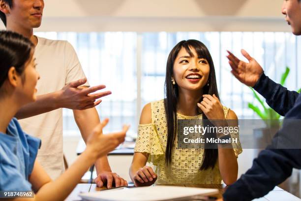 startup colleagues discussing in meeting - group h imagens e fotografias de stock