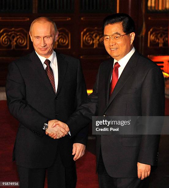 Russian Prime Minister Vladimir Putin shakes hands with Chinese President Hu Jintao at Wanliutang of Diaoyutai State Guest house on October 14, 2009...