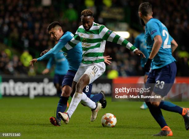 Moussa Dembele of Celtic is challenged by Matias Kranevitter of Zenit St Petersburg during UEFA Europa League Round of 32 match between Celtic and...