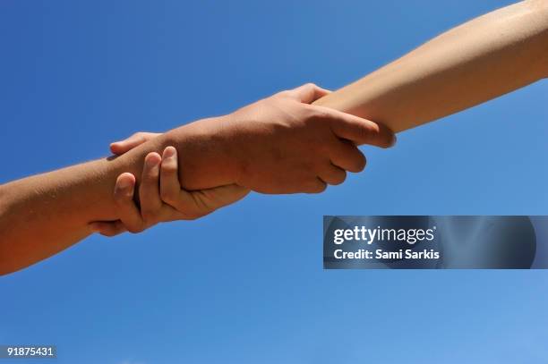 Man And Woman Outdoors Clasping Hands Closeup High-Res Stock Photo