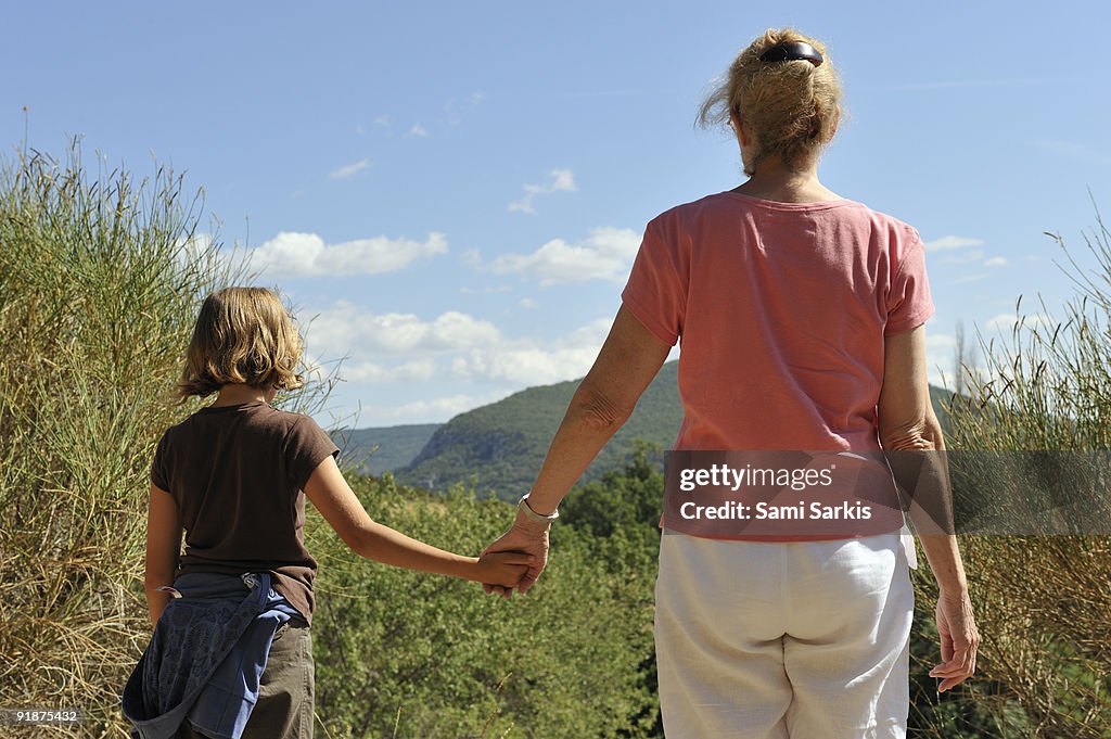 Grandmother holding grandddaugther's hand 