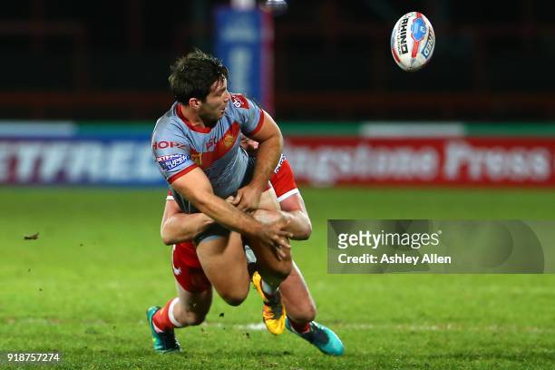 Jason Baitieri of the Catalans Dragons flicks the ball on to a team mate as Liam Salter of Hull KR tackles him during the BetFred Super League match...
