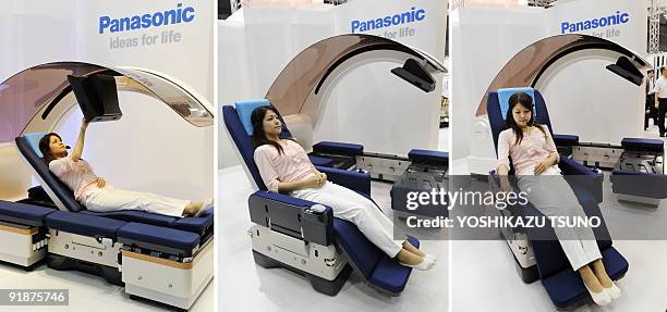 This combo picture shows Japanese electronoics giant Panasonic employee demonstrating a bed shaped robot which can be transformed between a bed and a...
