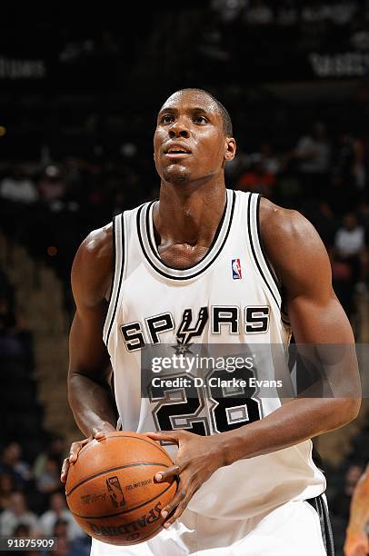 Ian Mahinmi of the San Antonio Spurs shoots a free throw during the preseason game against the Houston Rockets on October 6, 2009 at the AT&T Center...