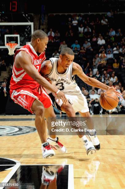 George Hill of the San Antonio Spurs drives to the basket against Kyle Lowry of the Houston Rockets during the preseason game on October 6, 2009 at...
