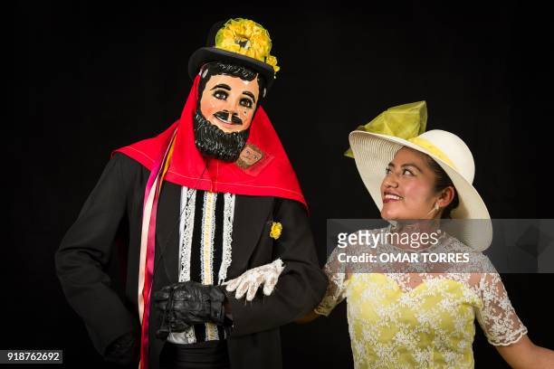 Mayra Cruz and Noe Vazquez pose in their "Catrines" costumes for the carnival in Tlaxcala, Mexico on February 13, 2018. The satirical costumes and...