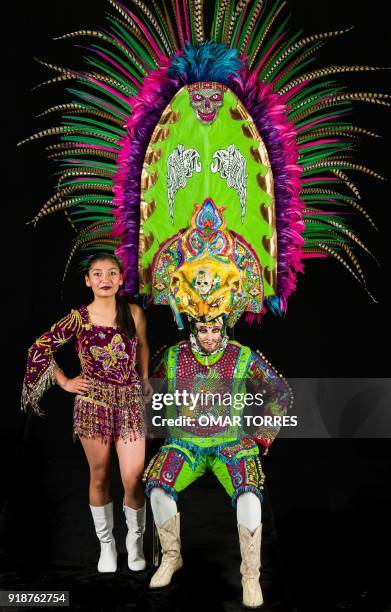 Melanie Michel Perez and Alfredo Alvarez pose in their costumes for the carnival in Tlaxcala, Mexico on February 13, 2018. The satirical costumes and...