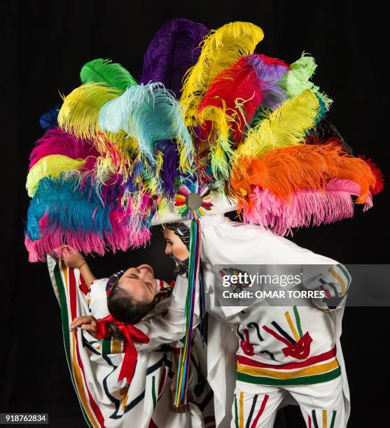 Kenia Vazquez and Paul Carro pose in one of the movements in the dance they peform during the carnival in Tlaxcala, Mexico on February 13, 2018. The...