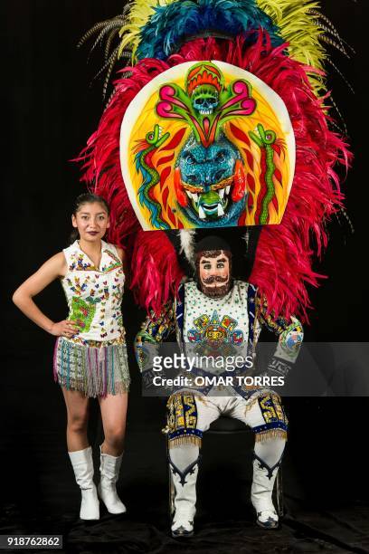 Melanie Perez and Arturo Beristain pose in their costumes for the carnival in Tlaxcala, Mexico on February 13, 2018. The satirical costumes and masks...