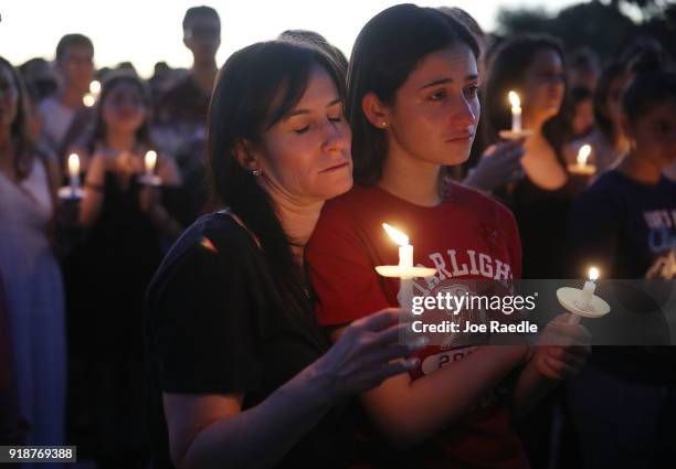 People attend a candlelight memorial service for the victims of the shooting at Marjory Stoneman Douglas High School that killed 17 people on...