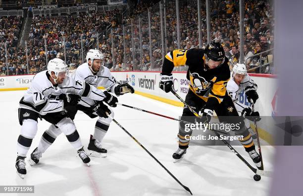 Evgeni Malkin of the Pittsburgh Penguins battles for the puck in the corner against Christian Folin of the Los Angeles Kings, Torrey Mitchell of the...