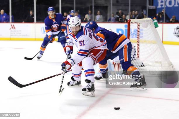 David Desharnais of the New York Rangers reaches for the puck against the New York Islanders in the first period during their game at Barclays Center...