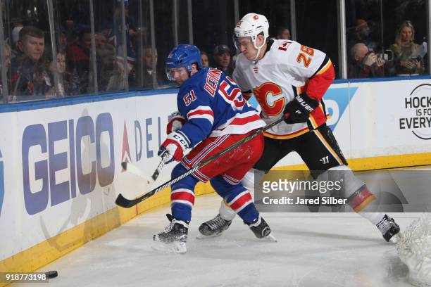 David Desharnais of the New York Rangers skates against Michael Stone of the Calgary Flames at Madison Square Garden on February 9, 2018 in New York...