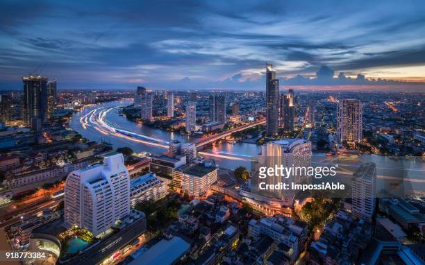 high angle view cities, building and chaophraya river curve at twilight - association of southeast asian nations foto e immagini stock