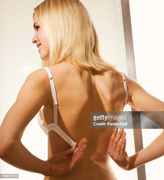 Young Woman Putting On Brarear View Photos and Premium High Res Pictures -  Getty Images