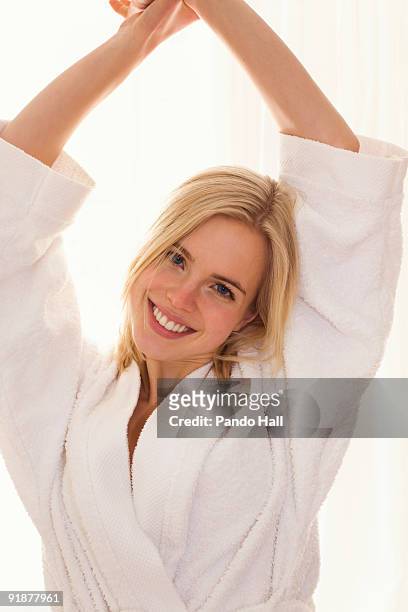 portrait of a young woman smiling, arms raised - woman smiling facing down stock pictures, royalty-free photos & images