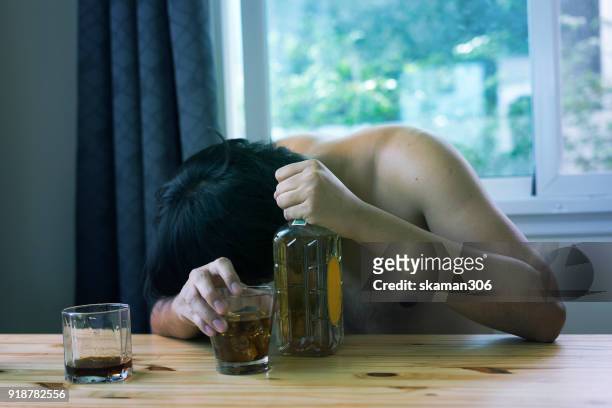 asian man stress and hand holding drink whiskey - drunk asian women stock pictures, royalty-free photos & images