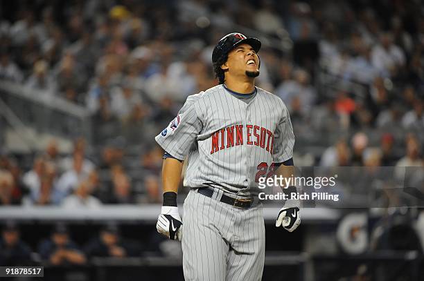 Carlos Gomez of the Minnesota Twins grimaces after being hit by a pitch during Game Two of the American League Division Series , against the New York...