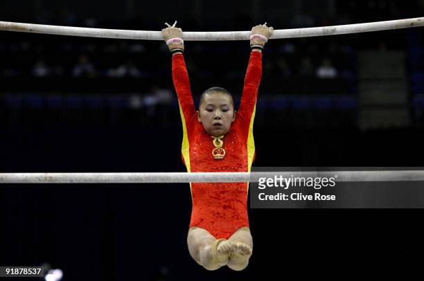 Kexin He of China competes in the uneven bars during the second day of the Artistic Gymnastics World Championships 2009 at O2 Arena on October 14,...