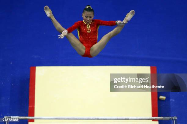 Kexin He of China competes in the uneven bars during the second day of the Artistic Gymnastics World Championships 2009 at O2 Arena on October 14,...