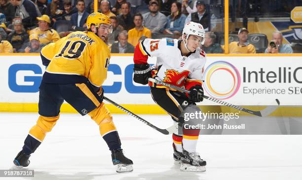 Johnny Gaudreau of the Calgary Flames skates against Calle Jarnkrok of the Nashville Predators during an NHL game at Bridgestone Arena on February...