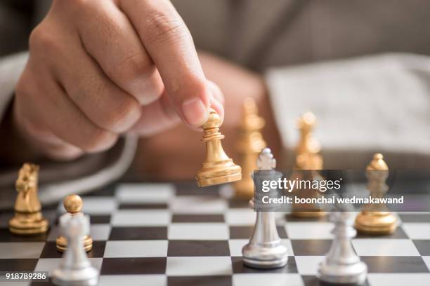 businessman hand with businessman goal with chess - chess fotografías e imágenes de stock